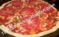 preparing a vegetable pizza